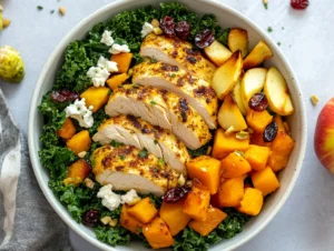 Bowl of roasted harvest bowls with maple turmeric chicken, butternut squash, Brussels sprouts, and goat cheese